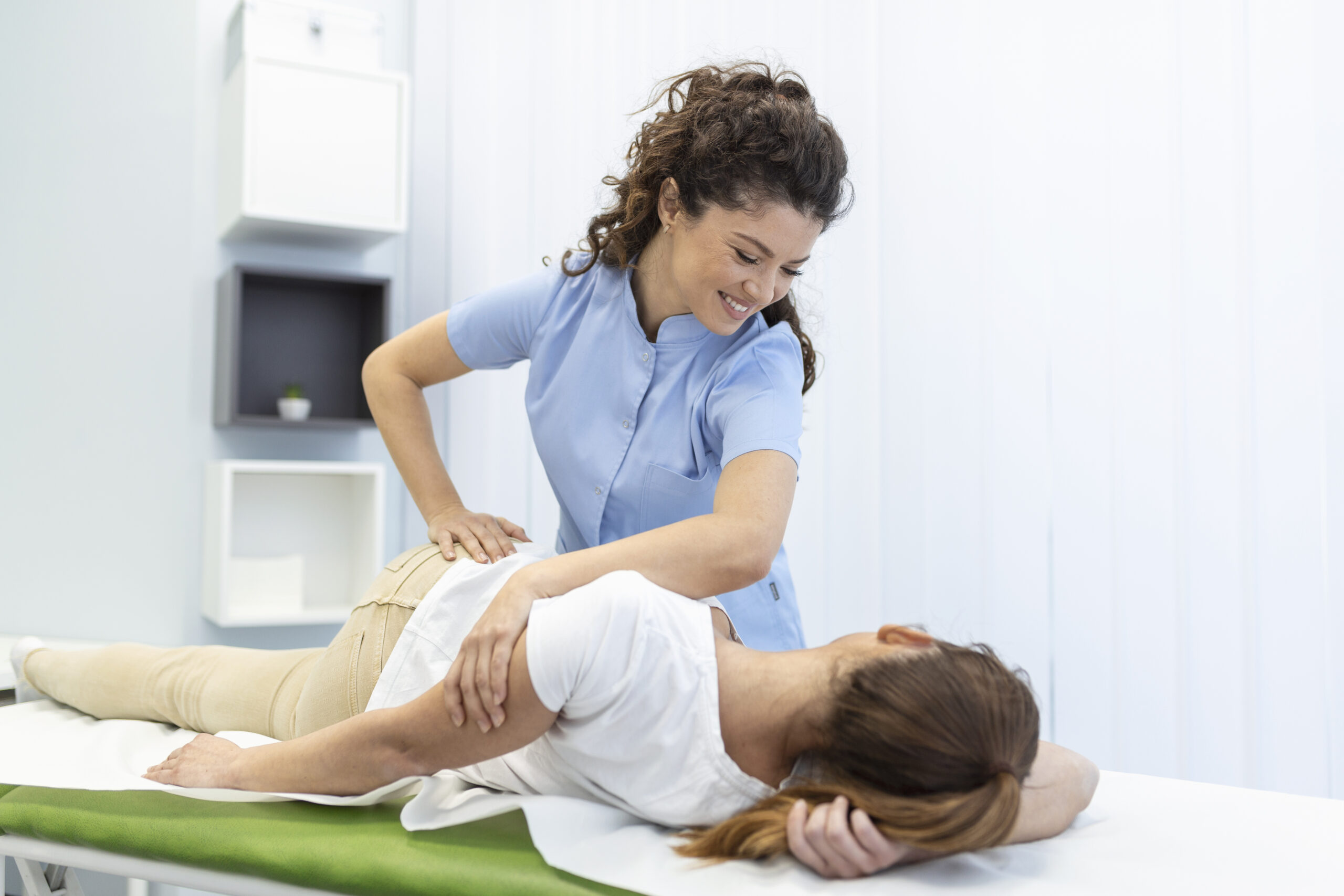 Chiropractor adjusting a patient's back near Orange City, FL